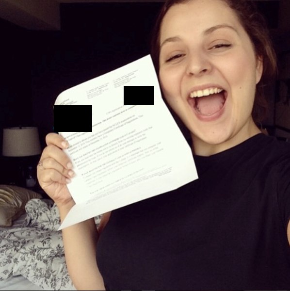 Image of Allie May, author holding NCLEX results