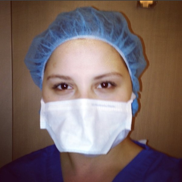 Allie May, author in scrubs and face mask