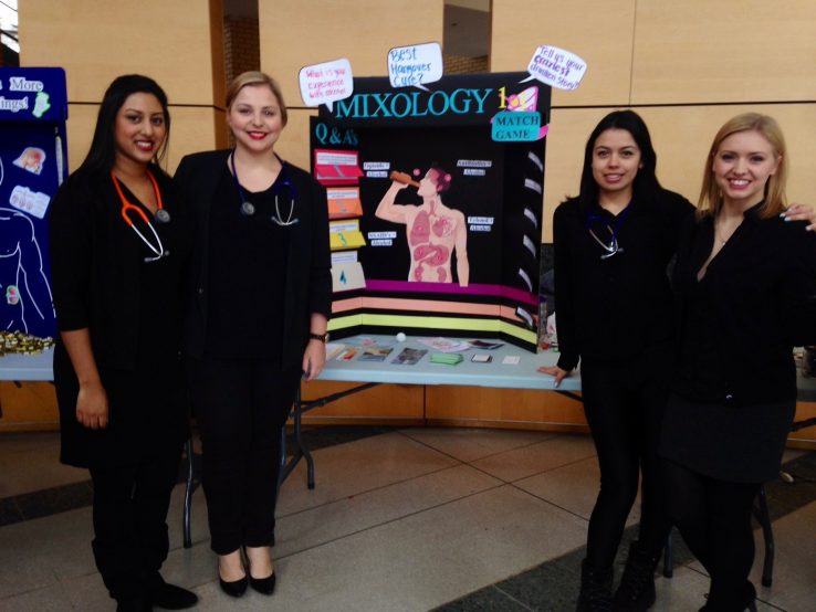 Allie May, author with class mates in front of exhibit