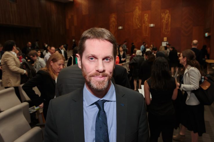 Profile of Dr. Rob Fowler with audience in background