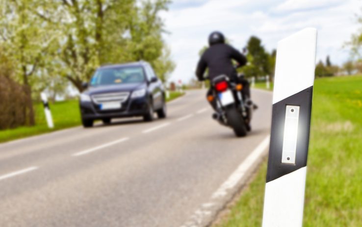 Car and motorbike on a country road - Focus on foreground