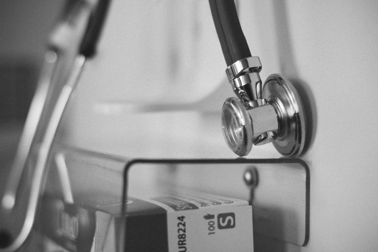 Photo of stethoscope in foreground in black and white