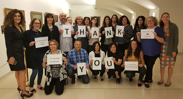 Nurses from JCT holding thank you signs for IHPME faculty