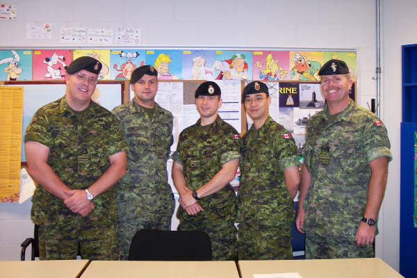 Andrew Lo second from right in camouflage uniform, with military colleagues