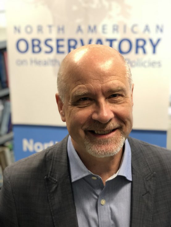 Profile of Greg Marchildon with North American Observatory on Health Systems and Policies banner in the background