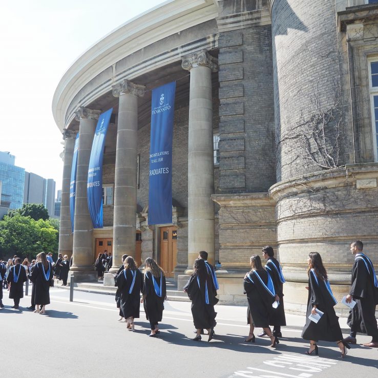 Graduating students in procession in front of U of T's Simcoe Hall
