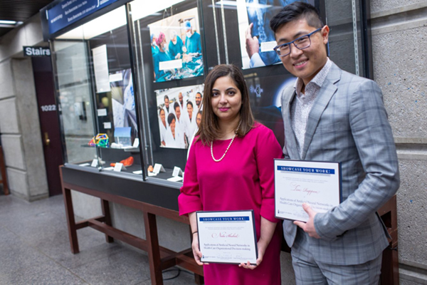 Nida Shahid and Tim Rappon with display case at Robarts Library