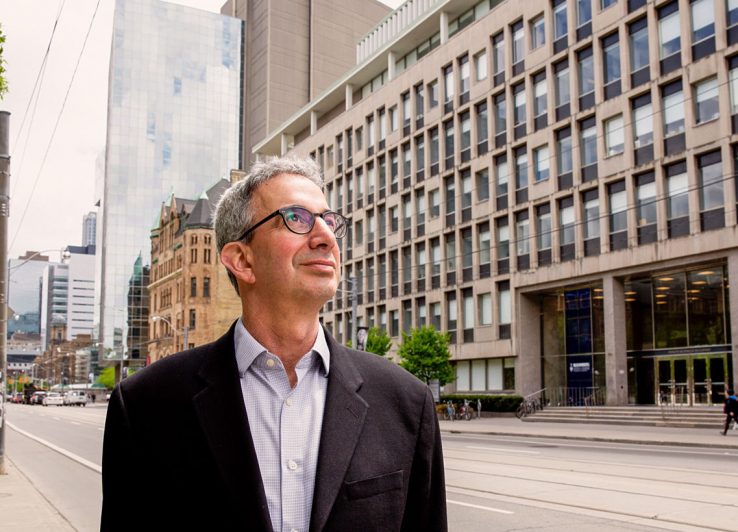 Profile of Robert Schwartz on College Street with Health Sciences Building in background