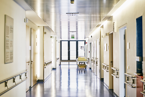 empty hospital corridor with doors and windows