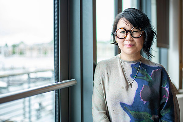 Profile of Dr. Sharon Kim next to window