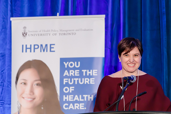 Audrey Laporte speaking with IHPME sign