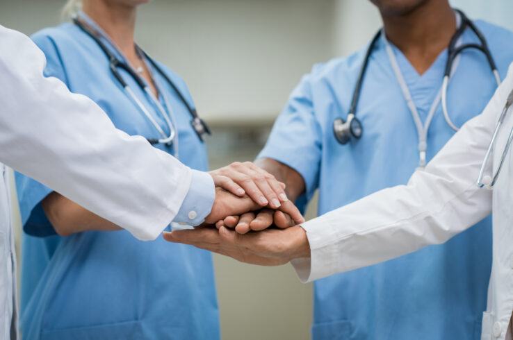 Stock image of health care workers in a huddle