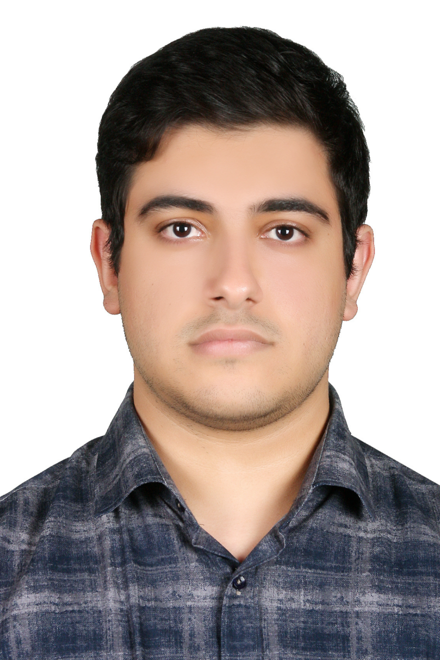 A portrait of a person, a 2025–26 Vector Scholar, with short dark hair wearing a blue and gray plaid shirt, in front of a plain white background.